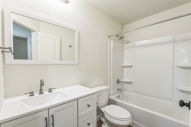 full bathroom featuring shower / bathing tub combination, vanity, a textured ceiling, and toilet