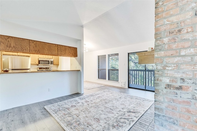 interior space featuring wood-type flooring and high vaulted ceiling