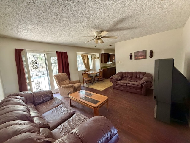 living room featuring a textured ceiling, ceiling fan, and dark hardwood / wood-style floors