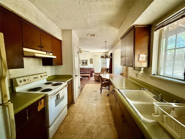 kitchen featuring pendant lighting, ceiling fan with notable chandelier, electric stove, and a textured ceiling