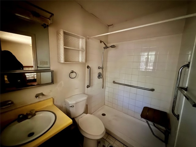 bathroom featuring toilet, sink, tile patterned flooring, and tiled shower