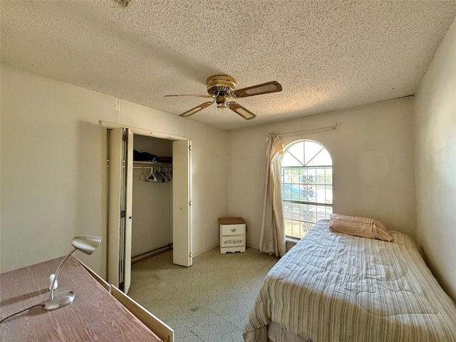 4710 Craigwood Dr, Austin, TX 78725 - bedroom featuring a textured ceiling, a closet, and a ceiling fan