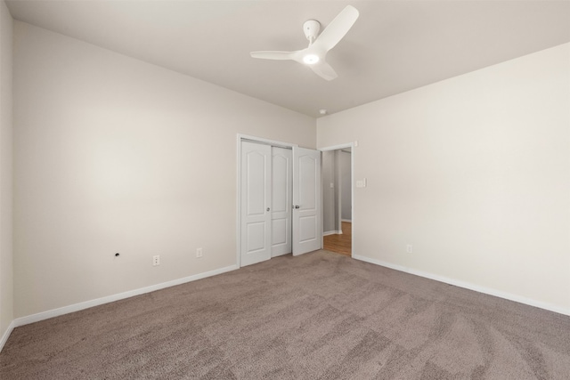 unfurnished bedroom featuring carpet flooring, a closet, and ceiling fan