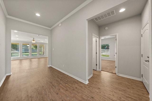 empty room with hardwood / wood-style flooring, ceiling fan, and ornamental molding