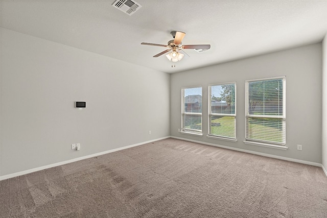 carpeted spare room with ceiling fan