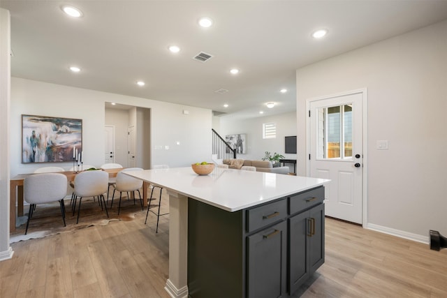 kitchen with a center island and light hardwood / wood-style flooring