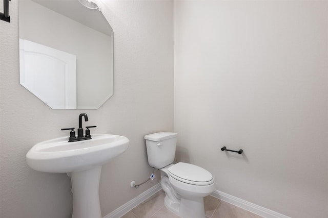 bathroom with tile patterned floors and toilet