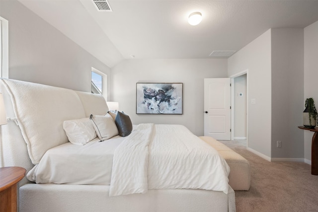 carpeted bedroom featuring vaulted ceiling