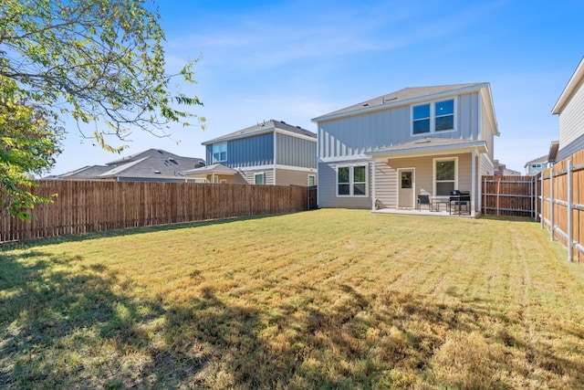 back of property featuring a patio area and a yard