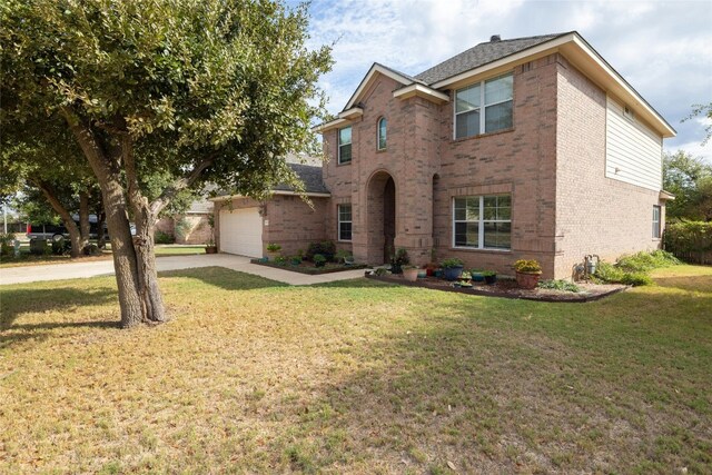 view of front of home featuring a garage and a front lawn