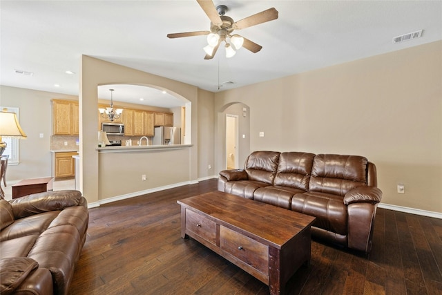2603 White Stallion Way, Leander, TX 78641 - living room with arched walkways, a ceiling fan, dark wood-style flooring, recessed lighting, and a chandelier