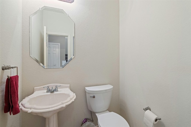 bathroom with toilet and sink