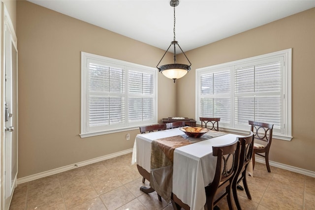 tiled dining space featuring a wealth of natural light