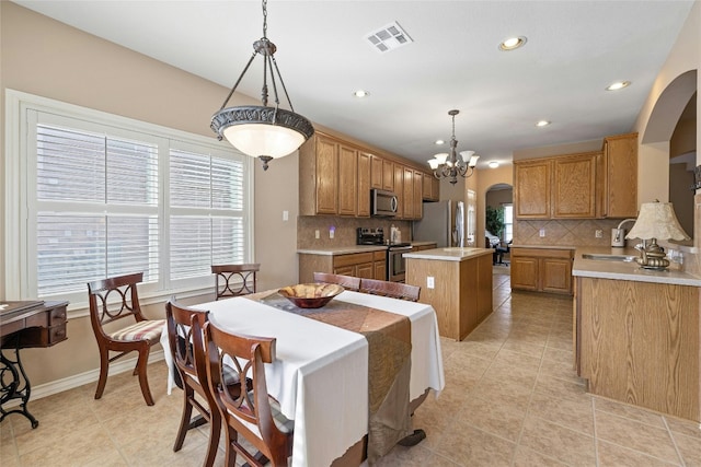 2603 White Stallion Way, Leander, TX 78641 - dining area with arched walkways, recessed lighting, a chandelier, and light tile patterned floors
