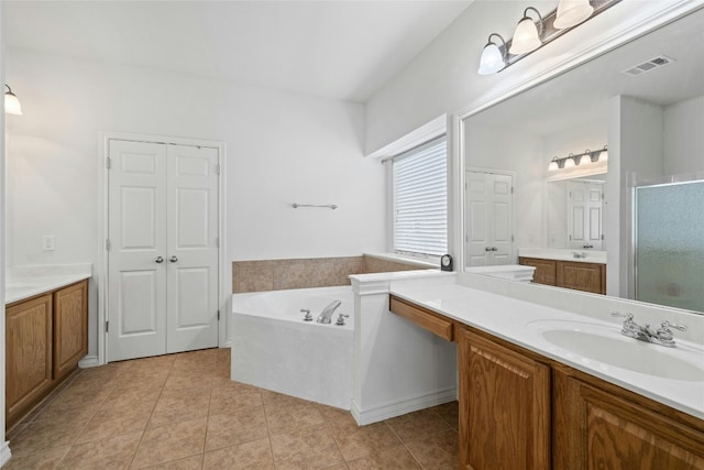 2603 White Stallion Way, Leander, TX 78641 - bathroom with a shower stall, two vanities, a garden tub, and tile patterned flooring