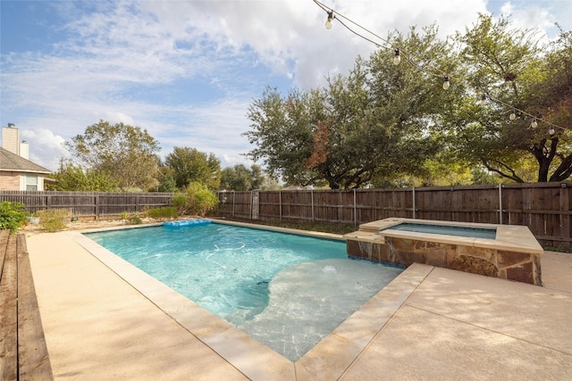 view of swimming pool with a patio area and an in ground hot tub