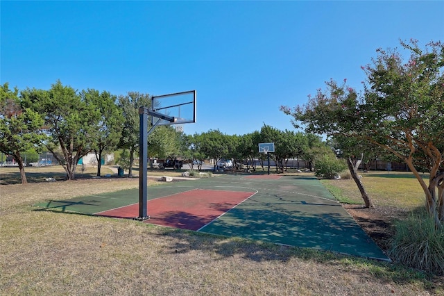 view of basketball court featuring a yard