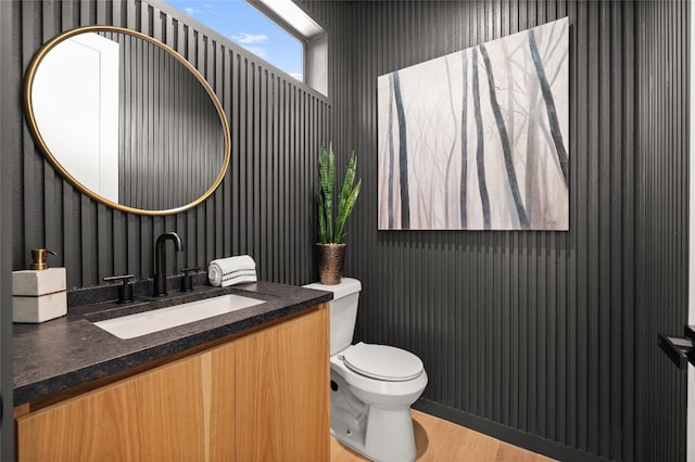 bathroom featuring hardwood / wood-style floors, vanity, and toilet