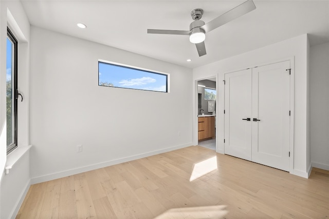 unfurnished bedroom with ceiling fan, a closet, and light hardwood / wood-style floors