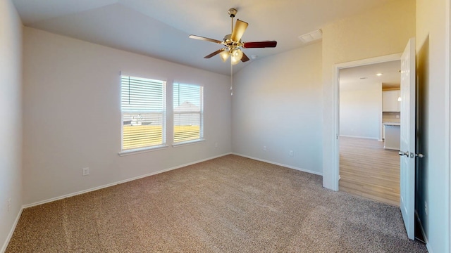 carpeted spare room with ceiling fan