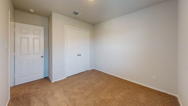 unfurnished bedroom featuring a closet and carpet floors