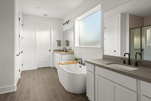 bathroom with vanity, wood-type flooring, and shower with separate bathtub