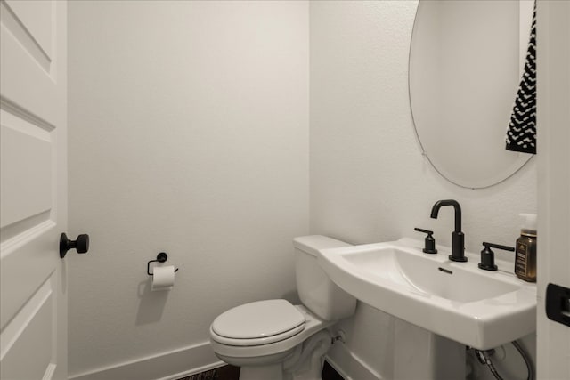 bathroom with toilet and sink