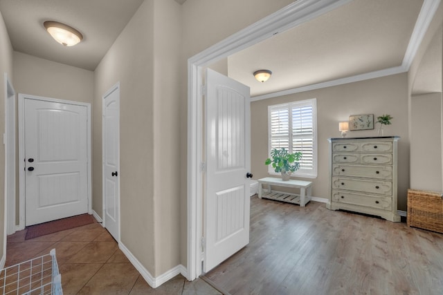 hallway featuring light hardwood / wood-style floors and ornamental molding