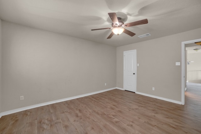 spare room featuring light hardwood / wood-style floors and ceiling fan