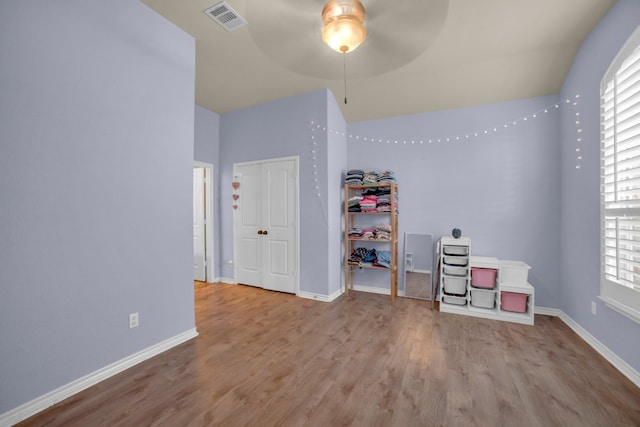 unfurnished bedroom with ceiling fan, light hardwood / wood-style floors, and a closet