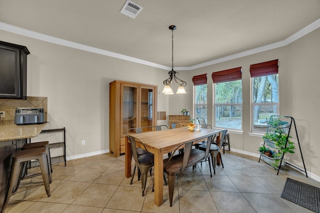 tiled dining room with ornamental molding