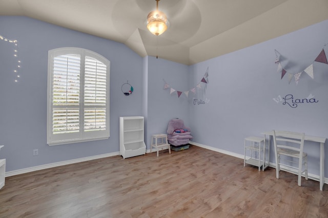 unfurnished bedroom with ceiling fan, light hardwood / wood-style floors, and vaulted ceiling