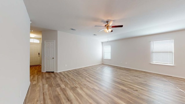 unfurnished room featuring light wood-type flooring and ceiling fan