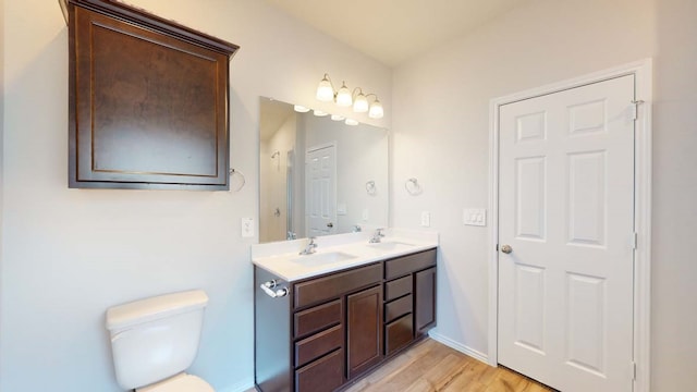 bathroom with hardwood / wood-style floors, vanity, and toilet