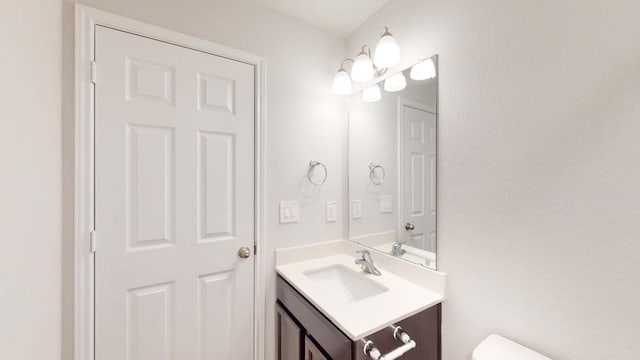 bathroom featuring vanity and toilet