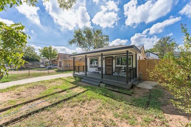 rear view of house featuring covered porch