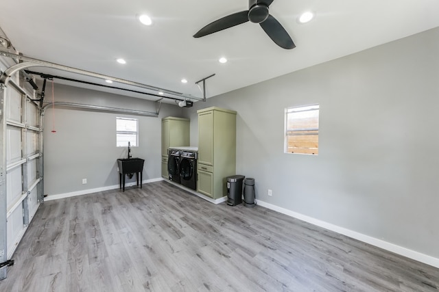 garage with independent washer and dryer, a garage door opener, and ceiling fan