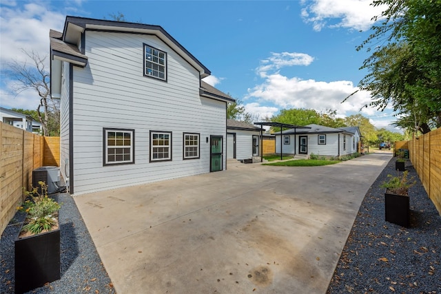 back of property featuring a patio and central AC