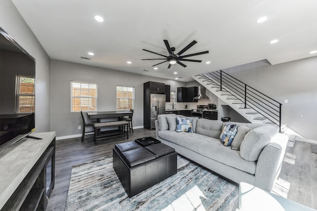 living room with dark hardwood / wood-style floors and ceiling fan