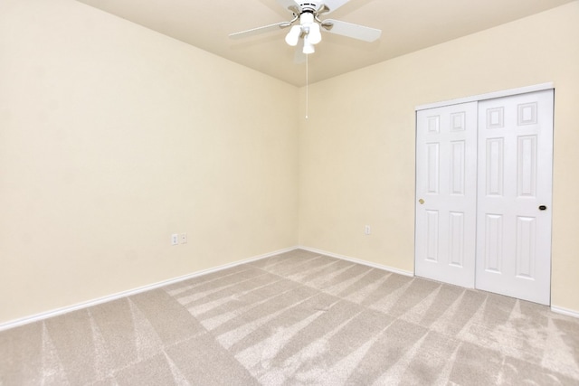 unfurnished bedroom featuring ceiling fan, a closet, and carpet floors