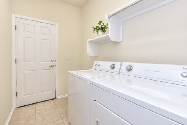 clothes washing area featuring light tile patterned flooring and independent washer and dryer