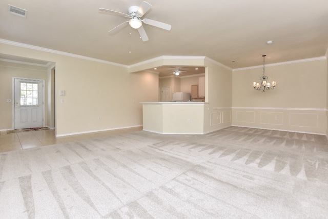 unfurnished living room with light carpet, ceiling fan with notable chandelier, and ornamental molding