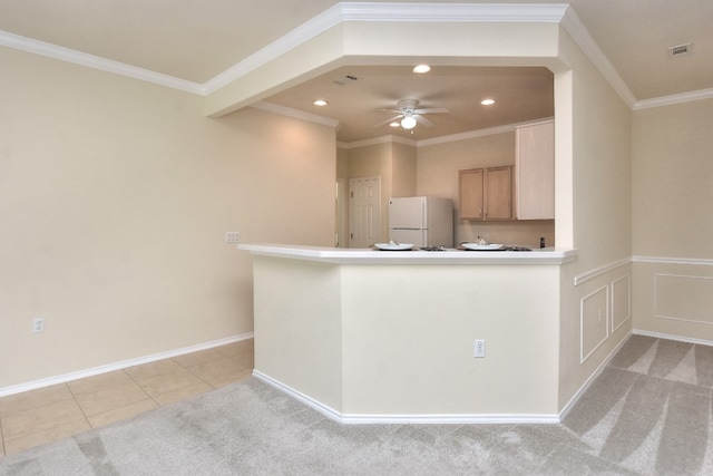 kitchen featuring white refrigerator, light colored carpet, crown molding, and light brown cabinetry