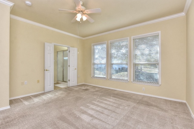 empty room featuring light colored carpet, ceiling fan, and crown molding