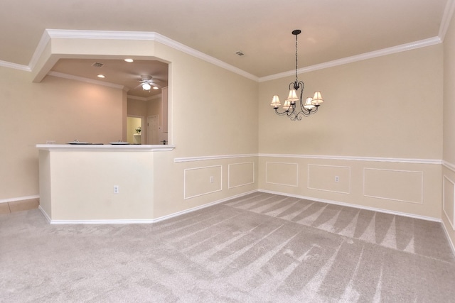 spare room featuring carpet flooring, crown molding, and ceiling fan with notable chandelier