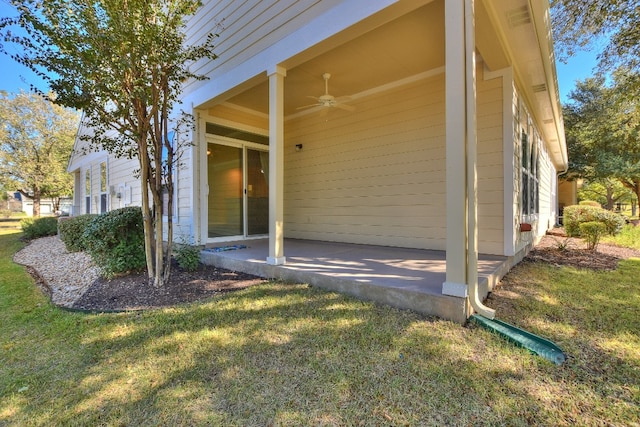 view of property exterior featuring a lawn and ceiling fan