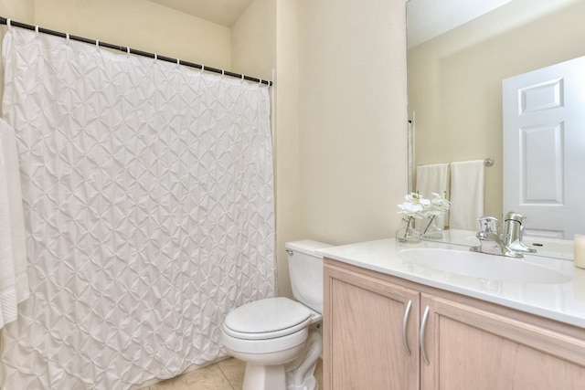 bathroom featuring tile patterned flooring, vanity, and toilet