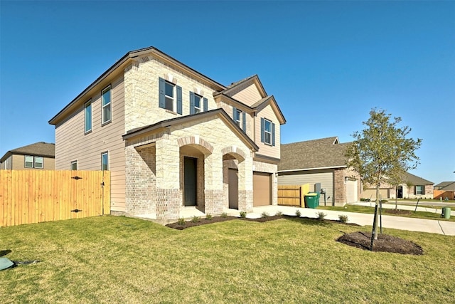 view of front of property featuring a front yard and a garage