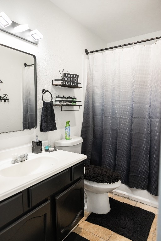 bathroom featuring tile patterned flooring, vanity, and toilet