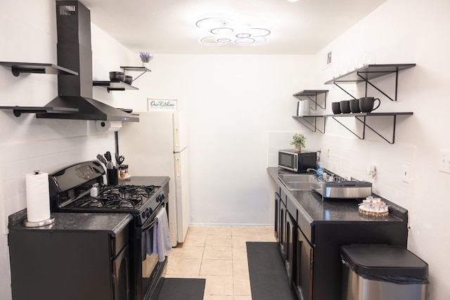 kitchen featuring gas stove, light tile patterned floors, sink, and extractor fan